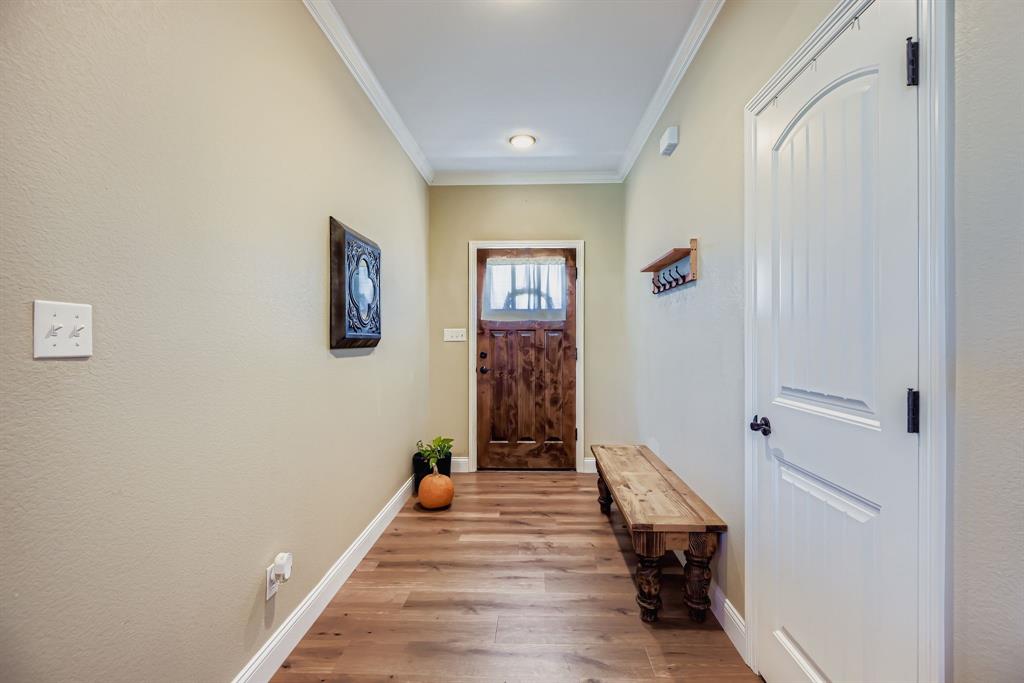 785 Schneider Road Howe, TX 75459 - Photo 10 of 40 Doorway with ornamental molding and wood finished floors