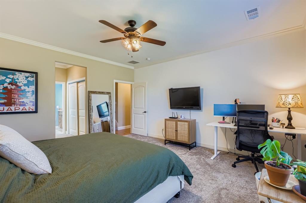 785 Schneider Road Howe, TX 75459 - Photo 12 of 40 Carpeted bedroom with crown molding, ceiling fan, an office area, a closet, and ensuite bath