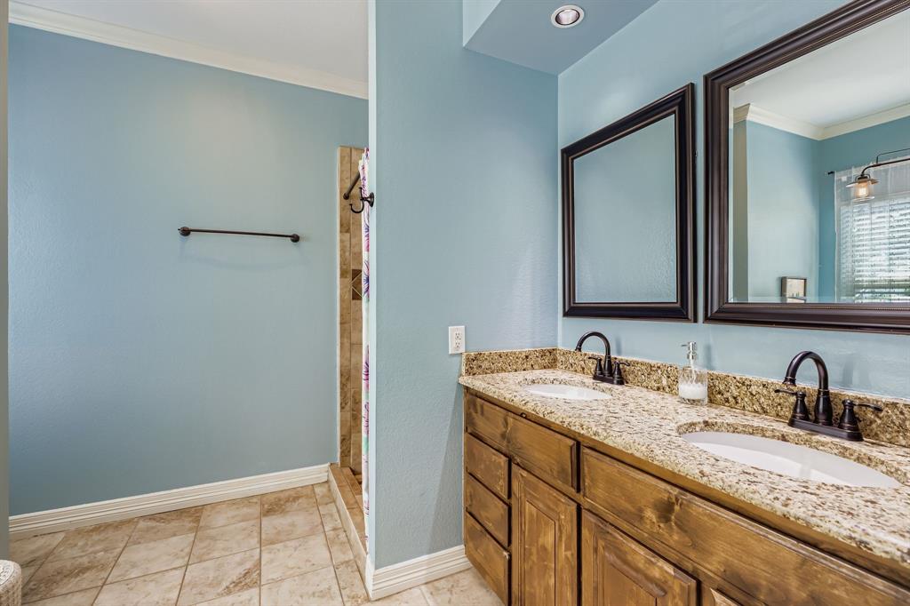 785 Schneider Road Howe, TX 75459 - Photo 14 of 40 Full bathroom with crown molding, double vanity, and walk in shower