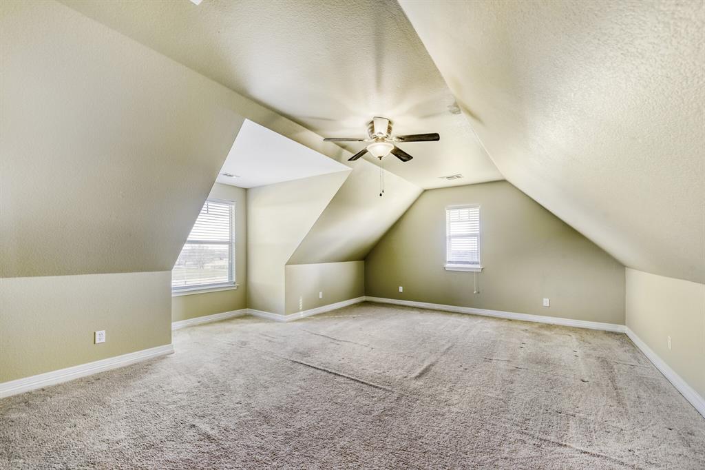 785 Schneider Road Howe, TX 75459 - Photo 15 of 40 Bonus room featuring ceiling fan, light colored carpet, and a textured ceiling