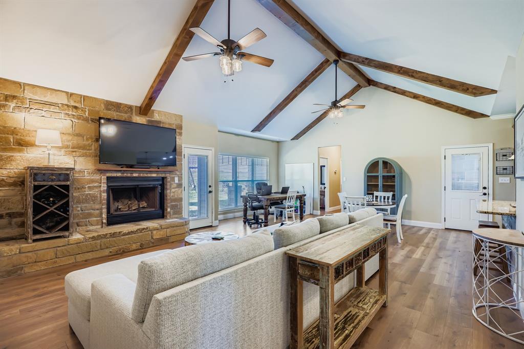 785 Schneider Road Howe, TX 75459 - Photo 18 of 40 Living area featuring dark wood-style floors, a fireplace, and a ceiling fan