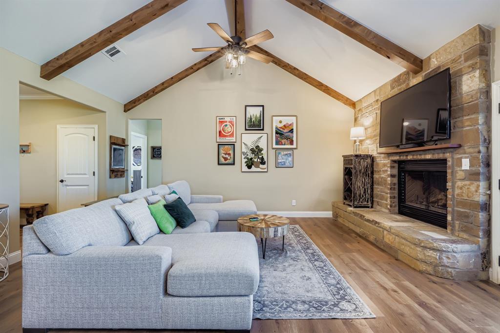 785 Schneider Road Howe, TX 75459 - Photo 19 of 40 Living room featuring a fireplace, wood finished floors, and ceiling fan