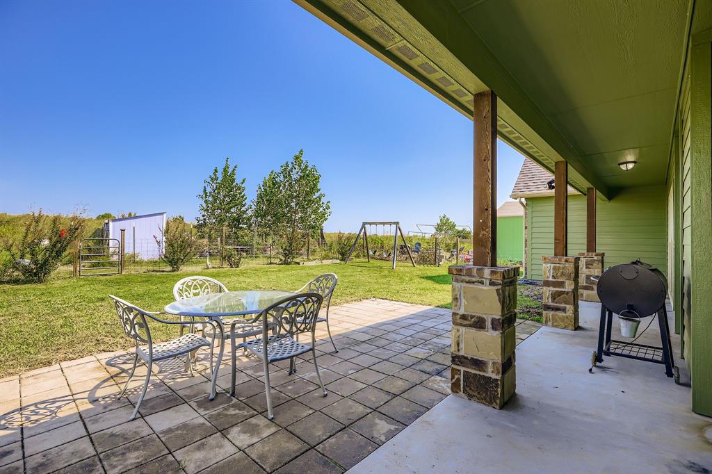 785 Schneider Road Howe, TX 75459 - Photo 30 of 40 View of patio with outdoor dining area, grilling area, and a playground