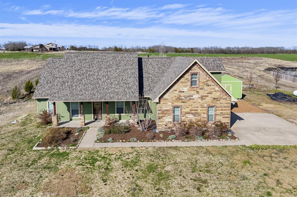 785 Schneider Road Howe, TX 75459 - Photo 31 of 40 View of front of property with a porch, roof with shingles, stone siding, and a front lawn