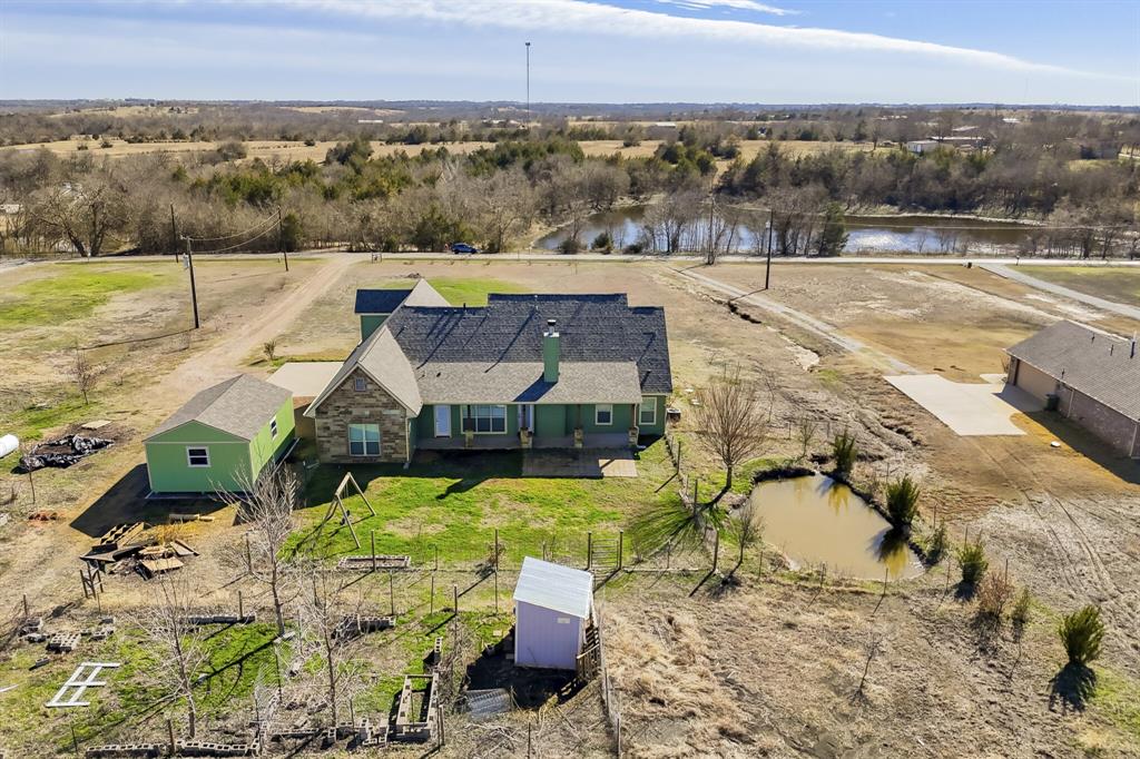 785 Schneider Road Howe, TX 75459 - Photo 35 of 40 View of subject property with a large body of water and a tree filled landscape