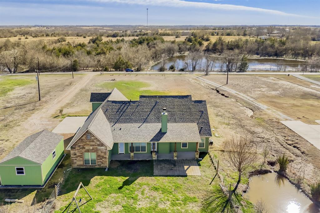 785 Schneider Road Howe, TX 75459 - Photo 36 of 40 Aerial view of property and surrounding area featuring a large body of water and a tree filled landscape