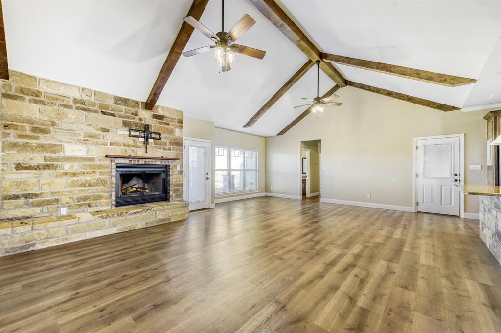 785 Schneider Road Howe, TX 75459 - Photo 4 of 40 Unfurnished living room featuring a fireplace and light wood-type flooring