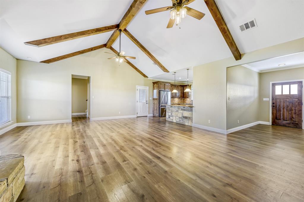 785 Schneider Road Howe, TX 75459 - Photo 5 of 40 Unfurnished living room featuring light wood-style flooring and ceiling fan