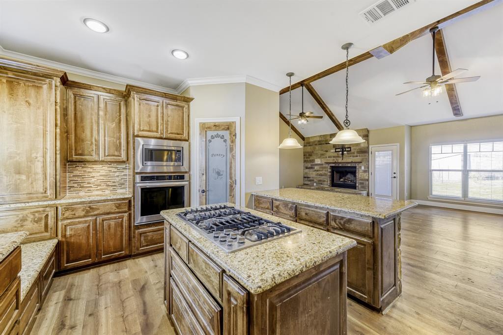 785 Schneider Road Howe, TX 75459 - Photo 40 of 40 Kitchen with a kitchen island, open floor plan, ceiling fan, pendant lighting, and lofted ceiling