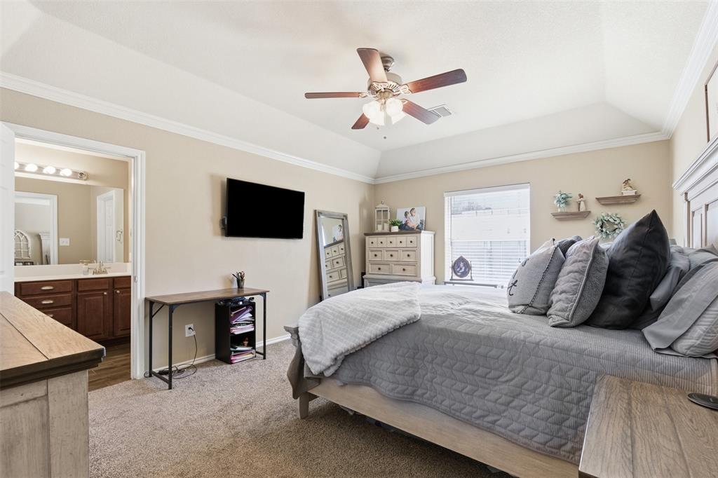 814 Chestnut Grove Drive Cleburne, TX 76033 - Photo 20 of 40 a bedroom with a bed and a flat screen tv