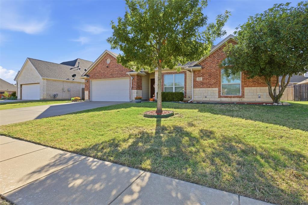 814 Chestnut Grove Drive Cleburne, TX 76033 - Photo 2 of 40 a house with a yard and a large tree