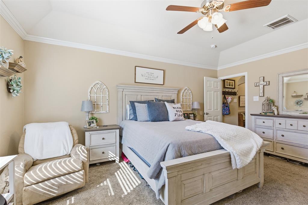 814 Chestnut Grove Drive Cleburne, TX 76033 - Photo 21 of 40 a bedroom with a bed and ceiling fan