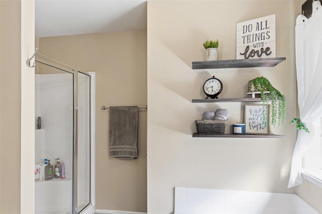 814 Chestnut Grove Drive Cleburne, TX 76033 - Photo 24 of 40 a bathroom with a bathtub and shower