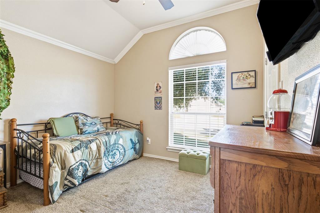 814 Chestnut Grove Drive Cleburne, TX 76033 - Photo 29 of 40 a bedroom with a bed and a dresser next to a window