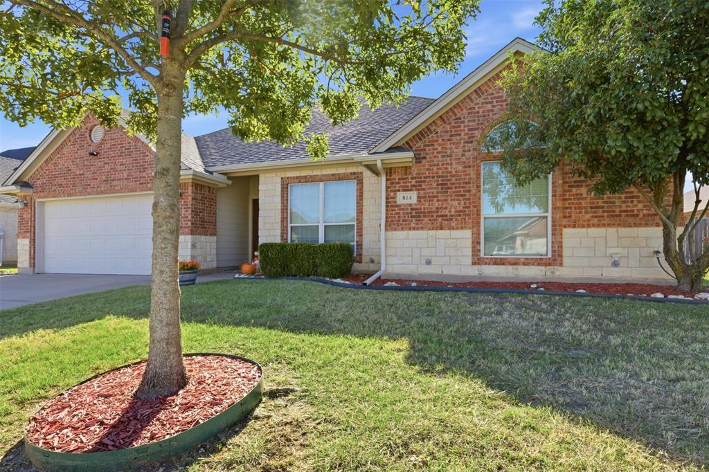 814 Chestnut Grove Drive Cleburne, TX 76033 - Photo 3 of 40 a front view of a house with garden