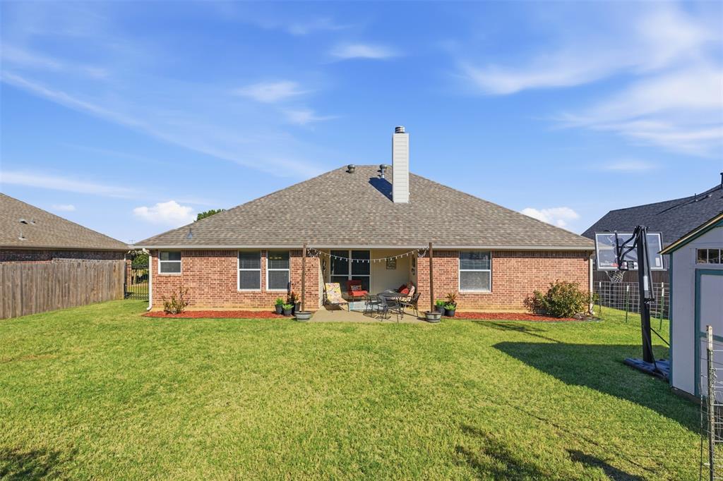 814 Chestnut Grove Drive Cleburne, TX 76033 - Photo 35 of 40 a house view with a sitting space and garden