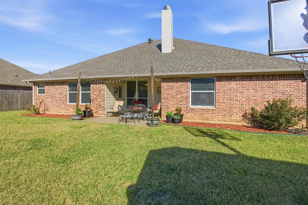 814 Chestnut Grove Drive Cleburne, TX 76033 - Photo 38 of 40 a front view of house with yard and outdoor seating