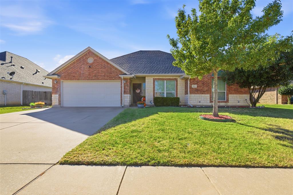 814 Chestnut Grove Drive Cleburne, TX 76033 - Photo 4 of 40 a house view with a garden space