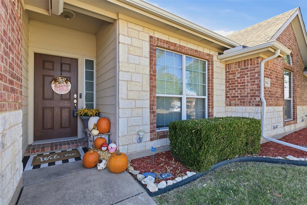 814 Chestnut Grove Drive Cleburne, TX 76033 - Photo 6 of 40 a front view of a house with patio furniture and front door