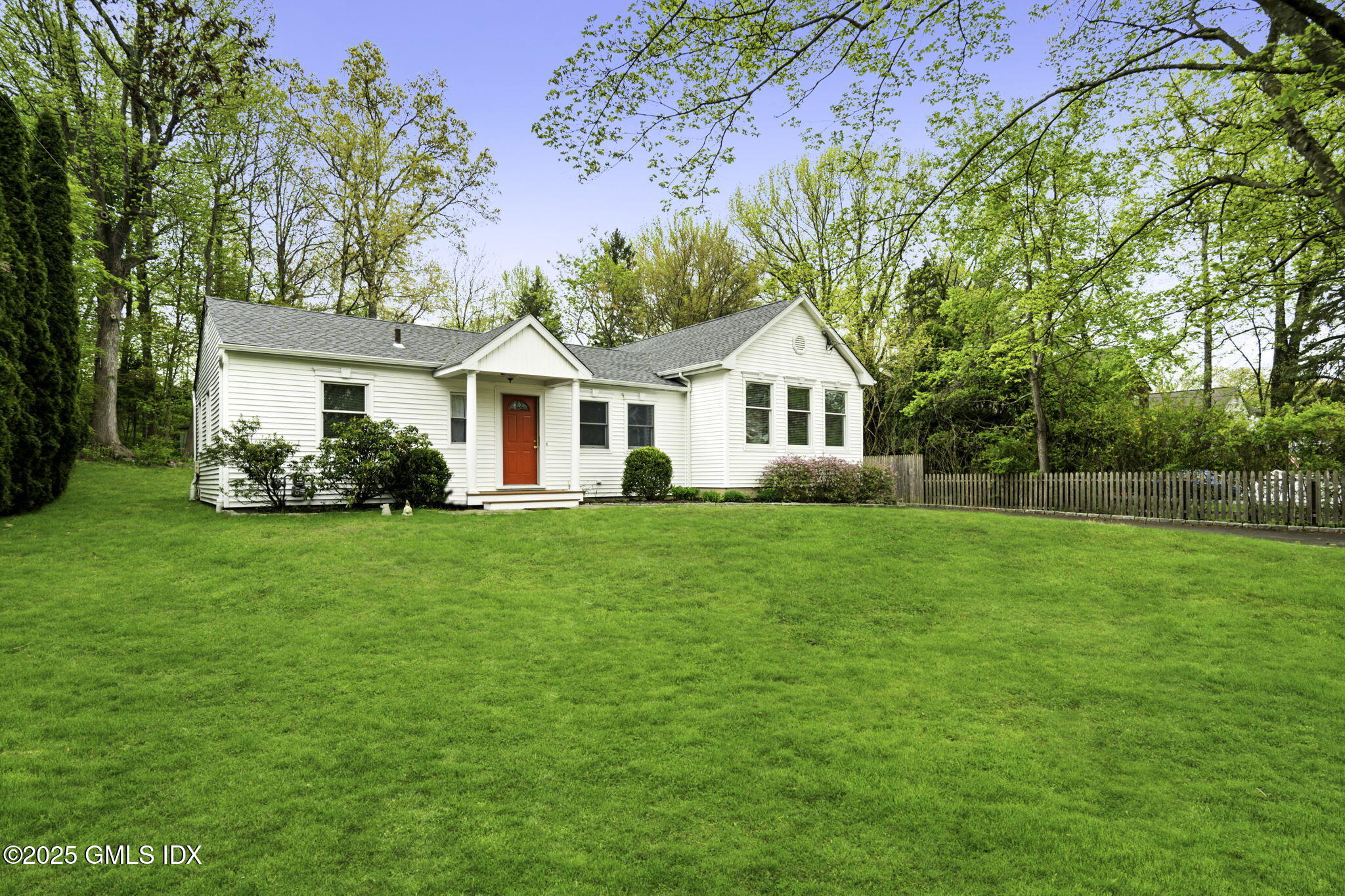 a front view of a house with a garden