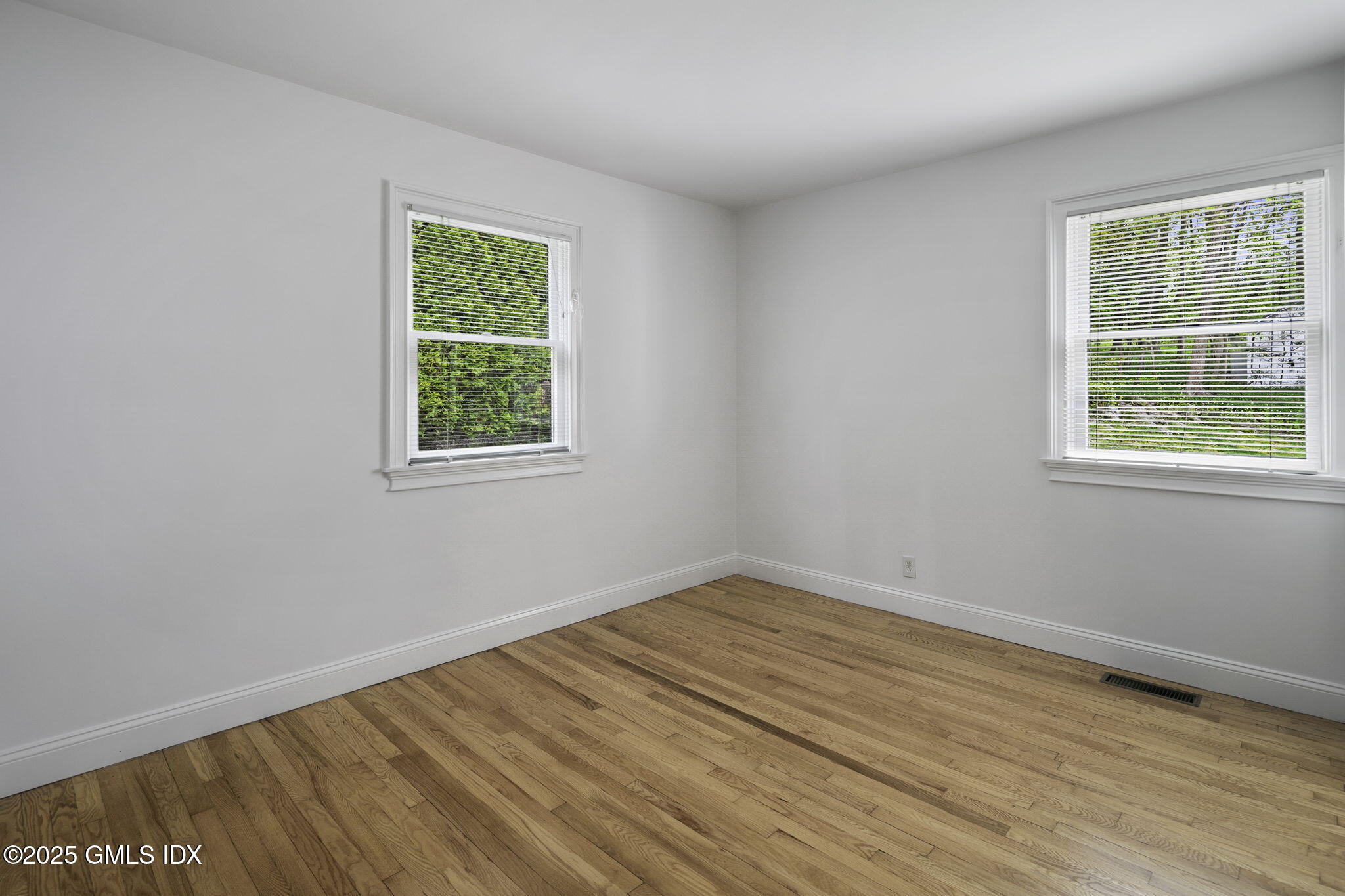 33 Circle Drive Greenwich, CT 06830 - Photo 18 of 22 a view of a room with wooden floor and windows