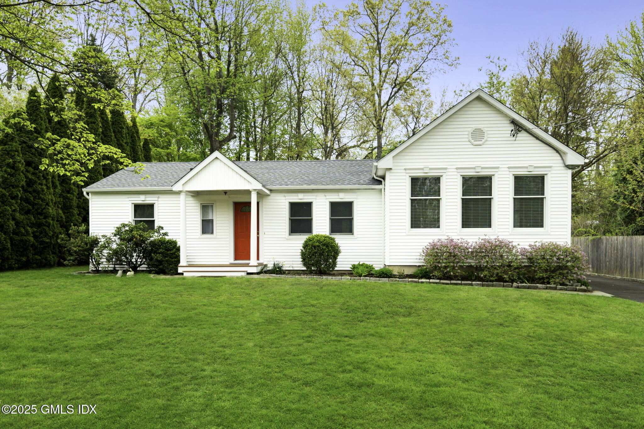 33 Circle Drive Greenwich, CT 06830 - Photo 2 of 22 a front view of a house with a yard