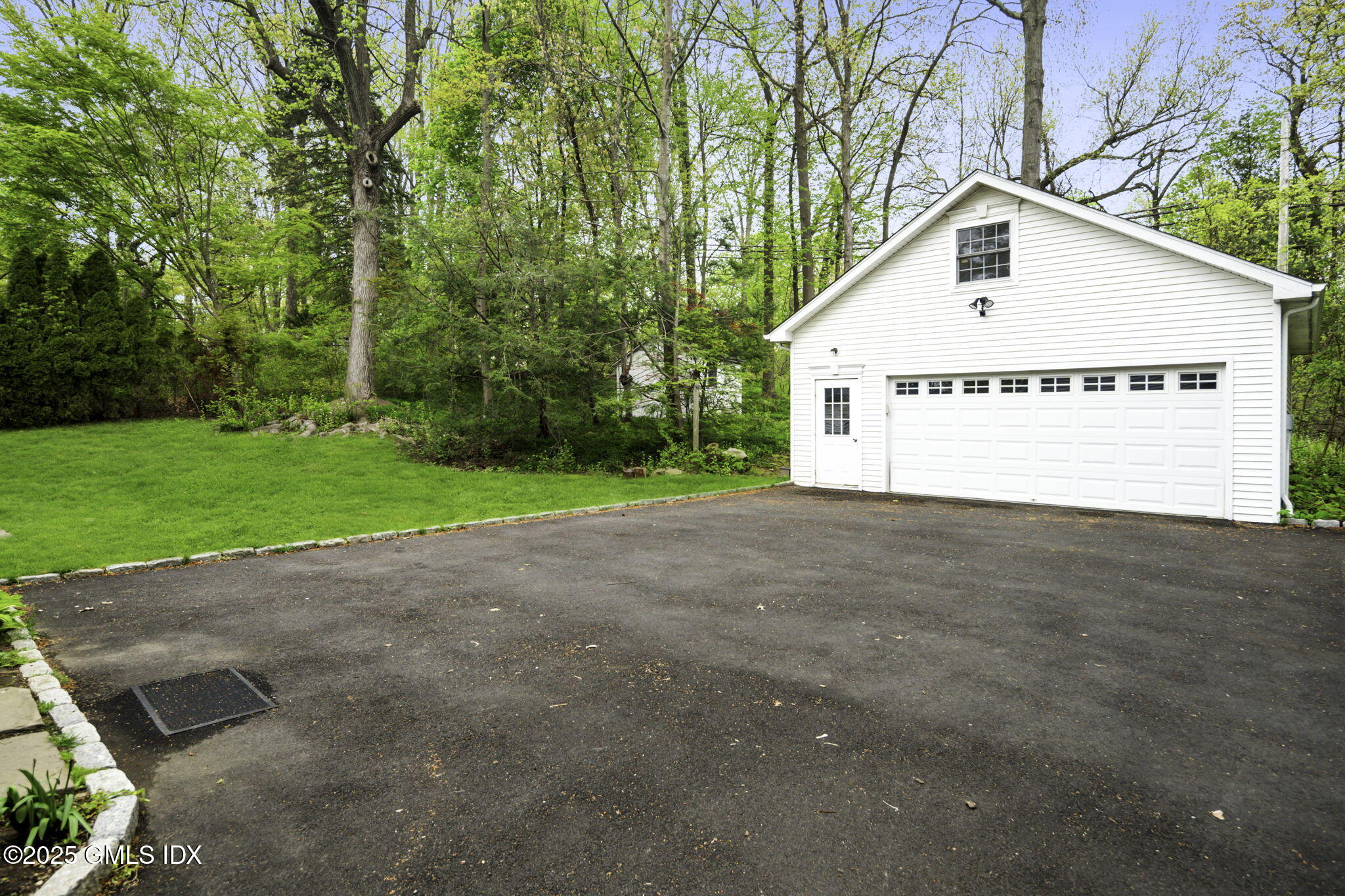 33 Circle Drive Greenwich, CT 06830 - Photo 6 of 22 a view of a white house with a yard and large trees