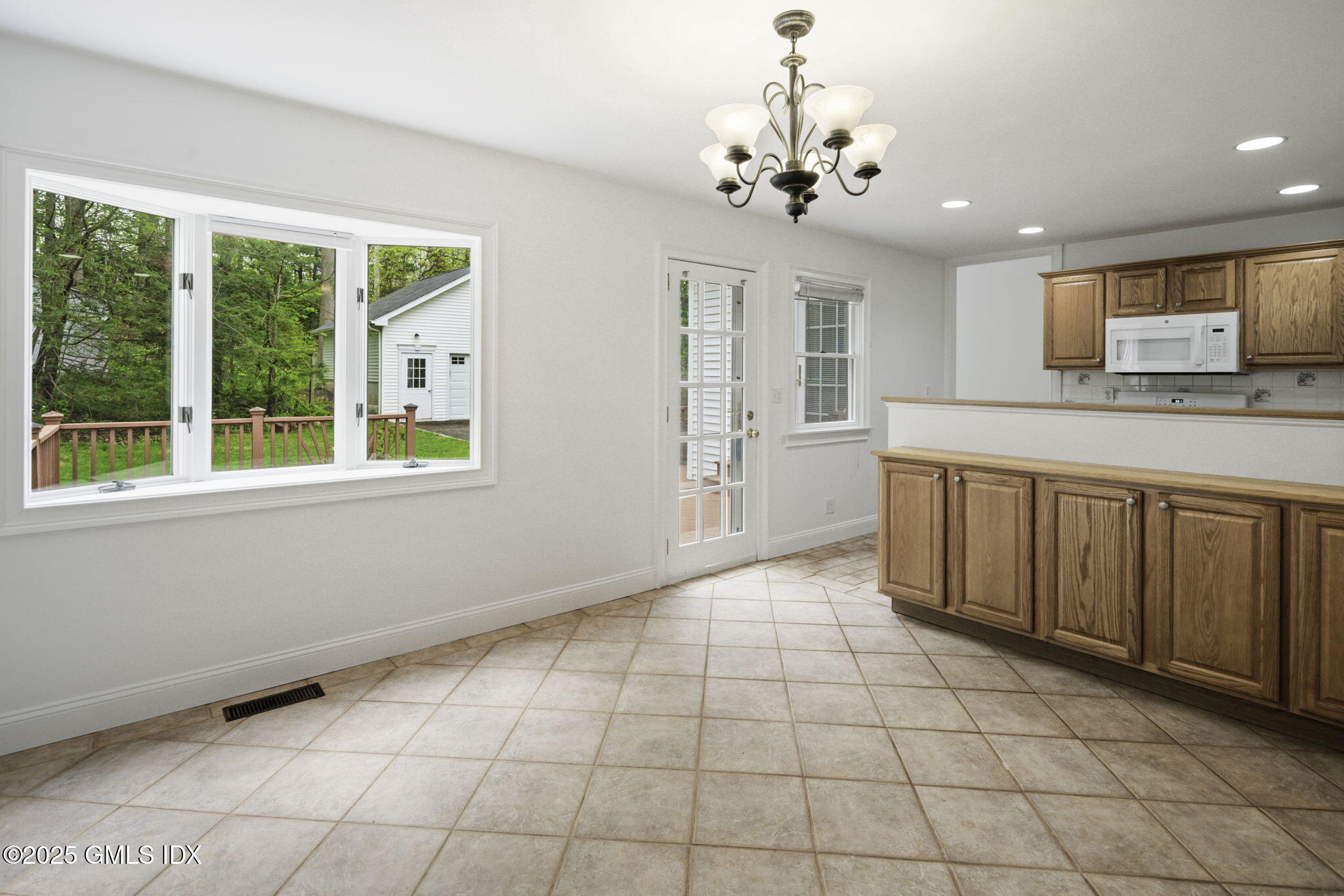 33 Circle Drive Greenwich, CT 06830 - Photo 10 of 22 a large white kitchen with a large window a sink and dishwasher