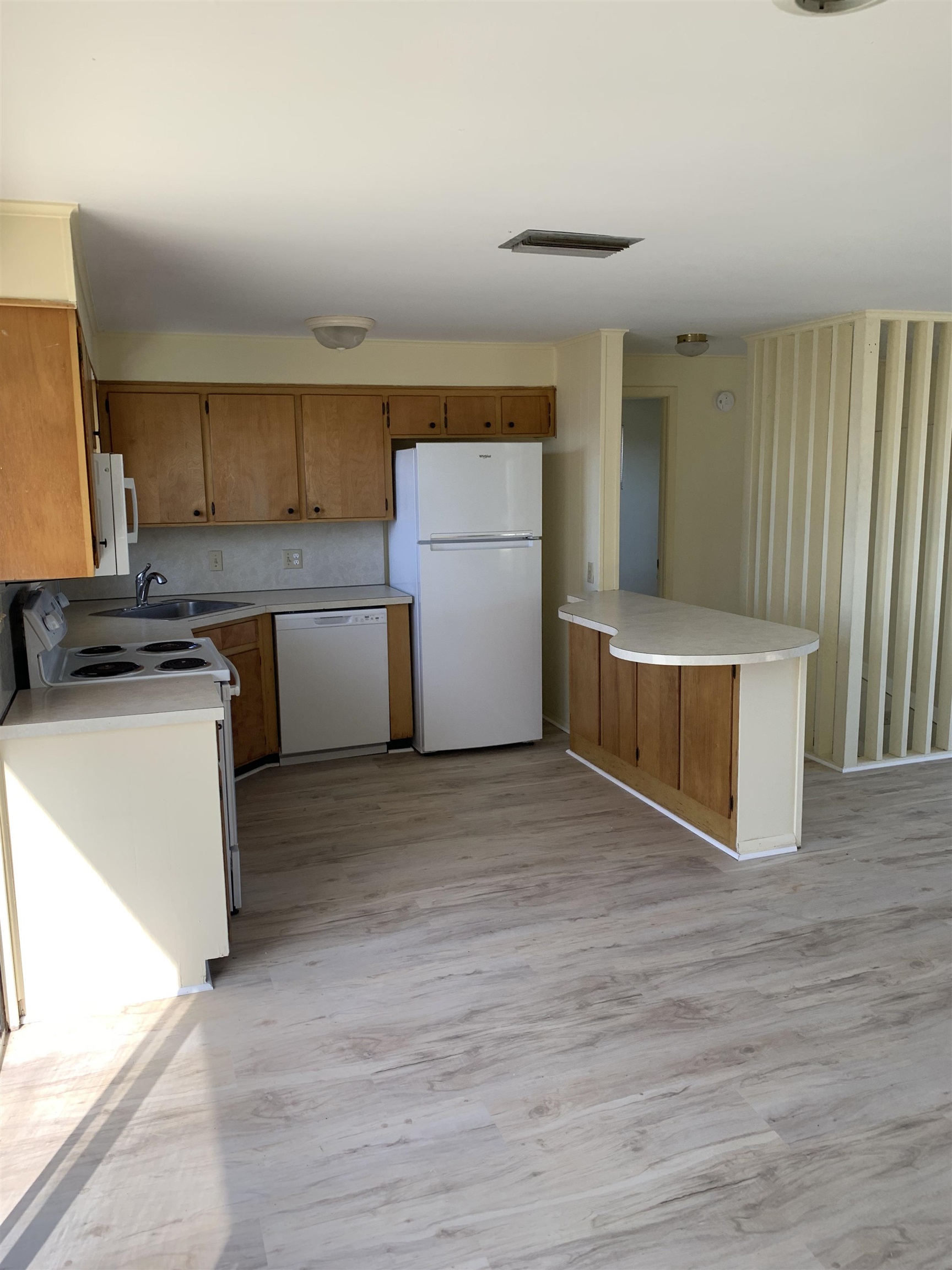 5343 Pelican Way St. Augustine, FL 32080 - Photo 21 of 29 a kitchen with cabinets and wooden floor
