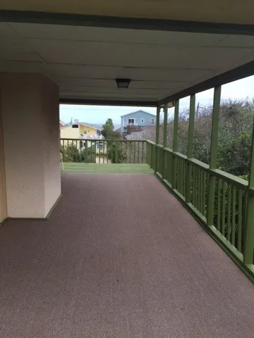 a view of balcony with wooden floor