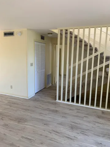 an empty room with wooden floor and closet