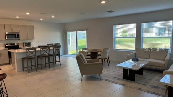 4520 Ranunculus Street Haines City, FL 33844 - Photo 2 of 19 a living room with furniture and a window