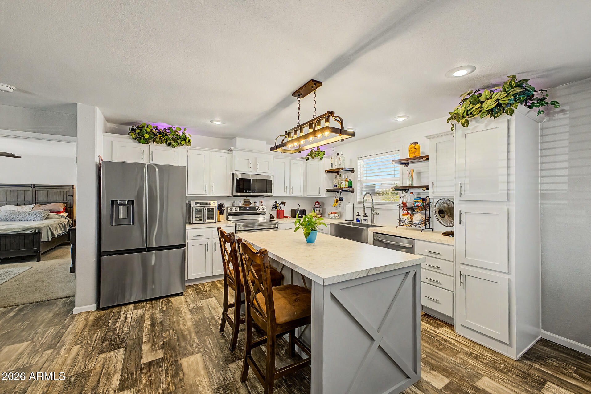 22417 West Dove Valley Road Wittmann, AZ 85361 - Photo 11 of 53 a kitchen with refrigerator and cabinets