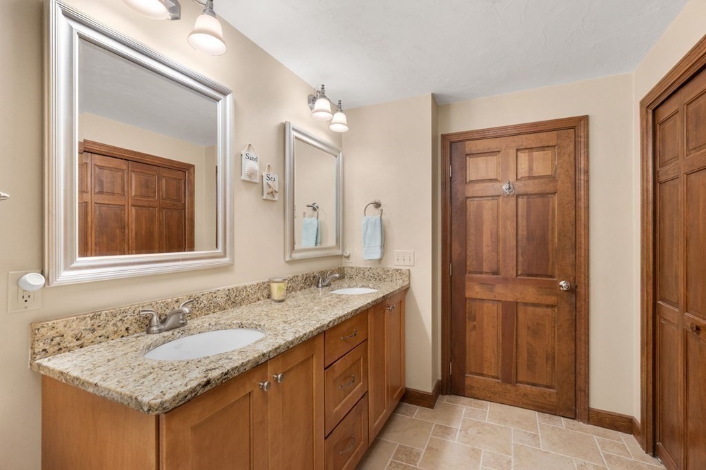 271 Pine Street Marshfield, MA 02050 - Photo 19 of 41 a bathroom with a granite countertop sink and a mirror