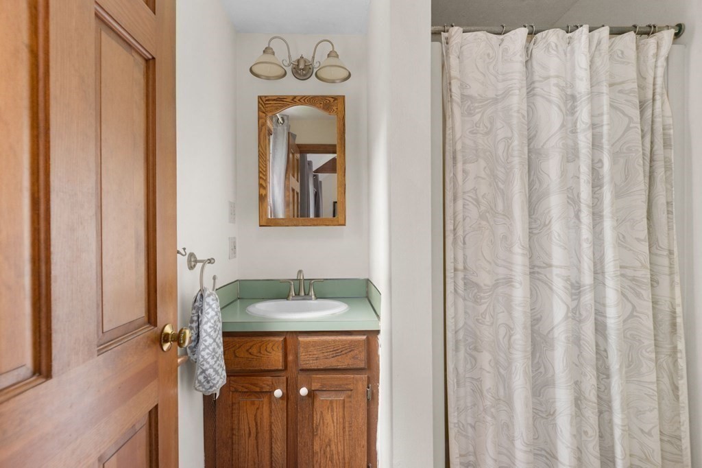 271 Pine Street Marshfield, MA 02050 - Photo 25 of 41 a bathroom with a granite countertop sink and a mirror