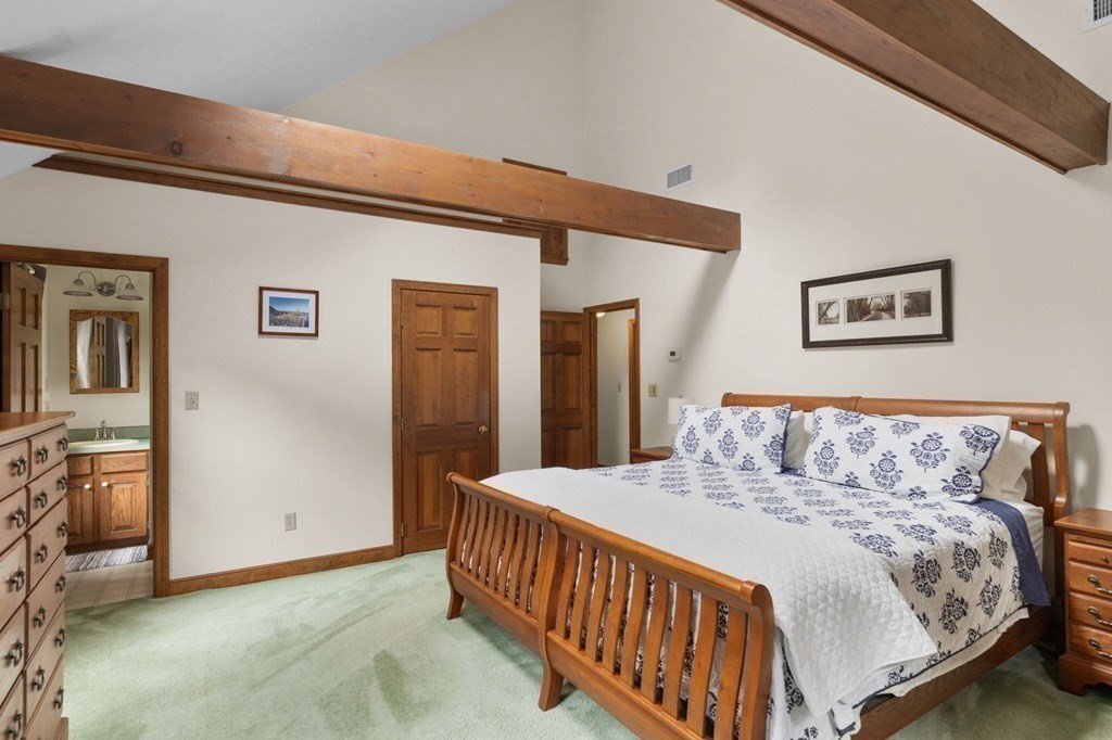 271 Pine Street Marshfield, MA 02050 - Photo 26 of 41 a bedroom with a large bed and a chandelier