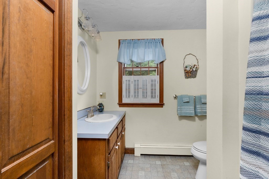 271 Pine Street Marshfield, MA 02050 - Photo 30 of 41 a bathroom with a sink a toilet and shower curtain