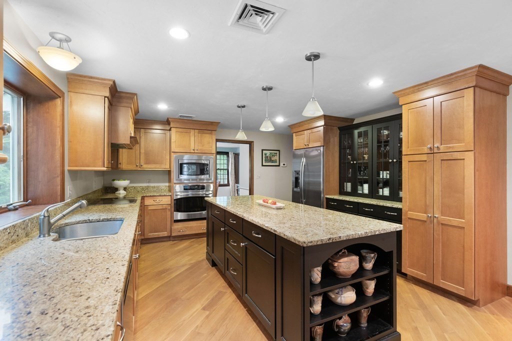 271 Pine Street Marshfield, MA 02050 - Photo 3 of 41 a large kitchen with stainless steel appliances a large counter top a stove and a refrigerator
