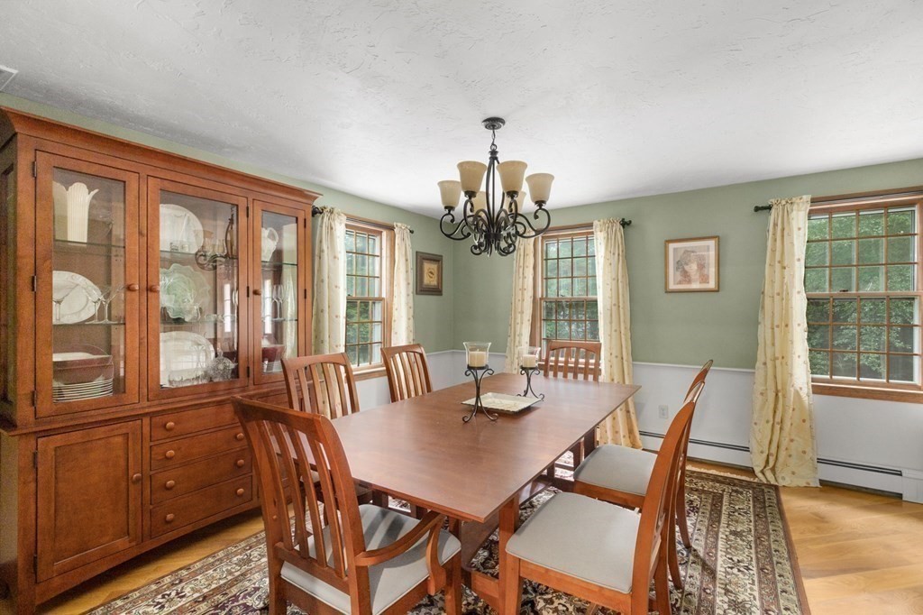 271 Pine Street Marshfield, MA 02050 - Photo 10 of 41 a view of a dining room with furniture large windows and wooden floor