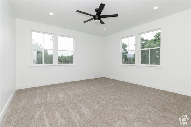 195 West 300 North Logan, UT 84321 - Photo 12 of 20 Empty room featuring light carpet, recessed lighting, and a ceiling fan