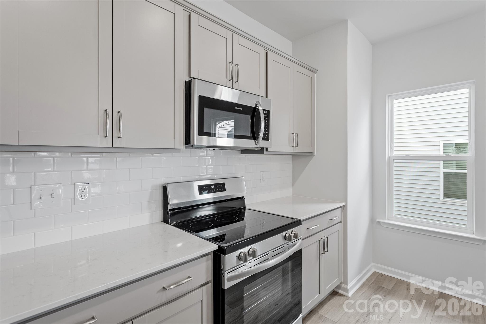 5869 Tuckaseegee Road, Unit 1 Charlotte, NC 28208 - Photo 11 of 30 a kitchen with cabinets appliances and a window