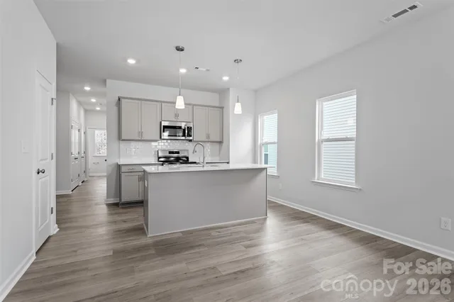 a kitchen with granite countertop a sink a stove and kitchen island