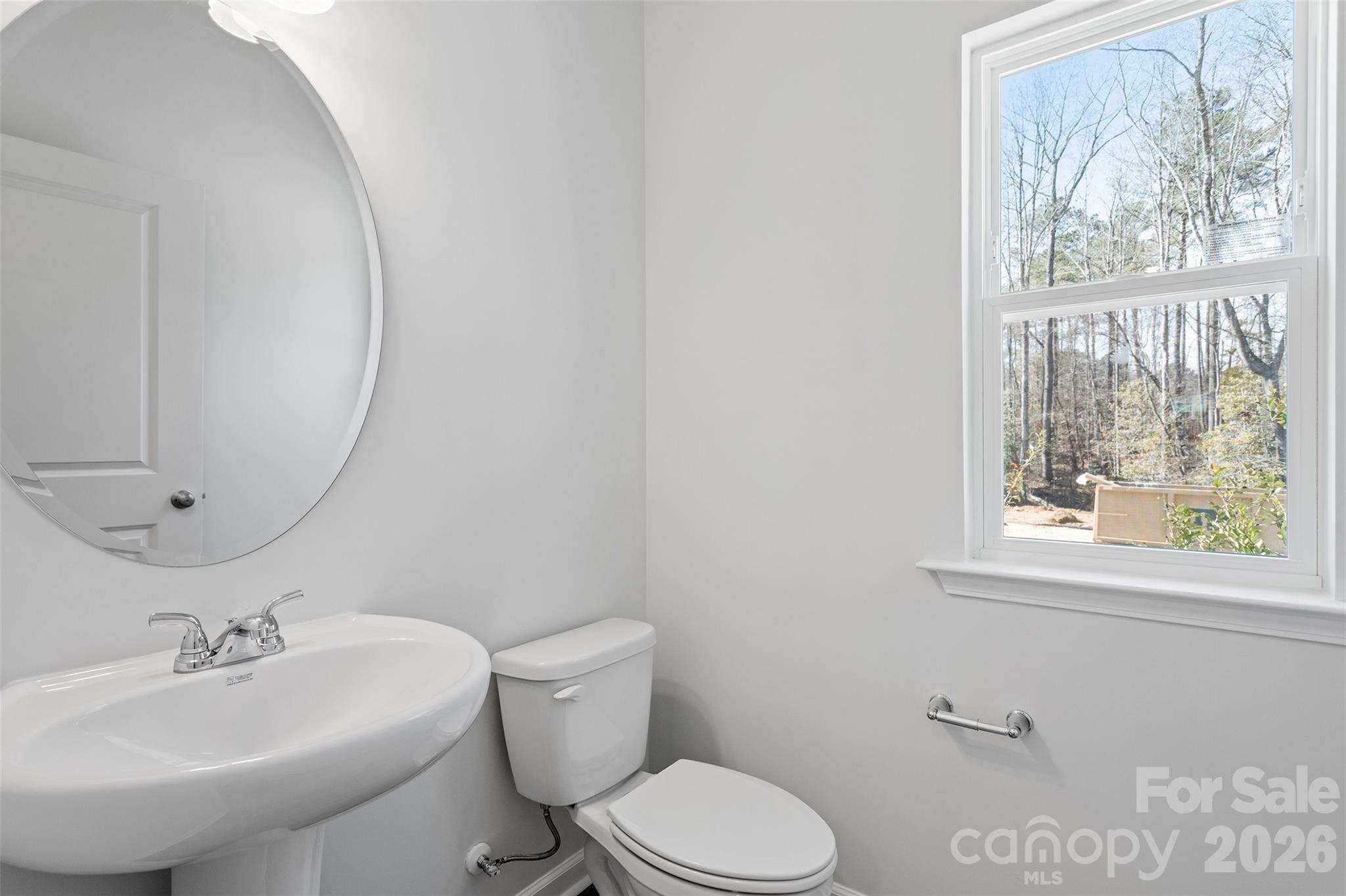 5869 Tuckaseegee Road, Unit 1 Charlotte, NC 28208 - Photo 28 of 30 a bathroom with a toilet sink and mirror
