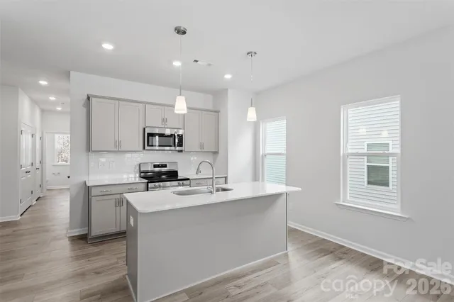 a kitchen with a stove a sink and a refrigerator