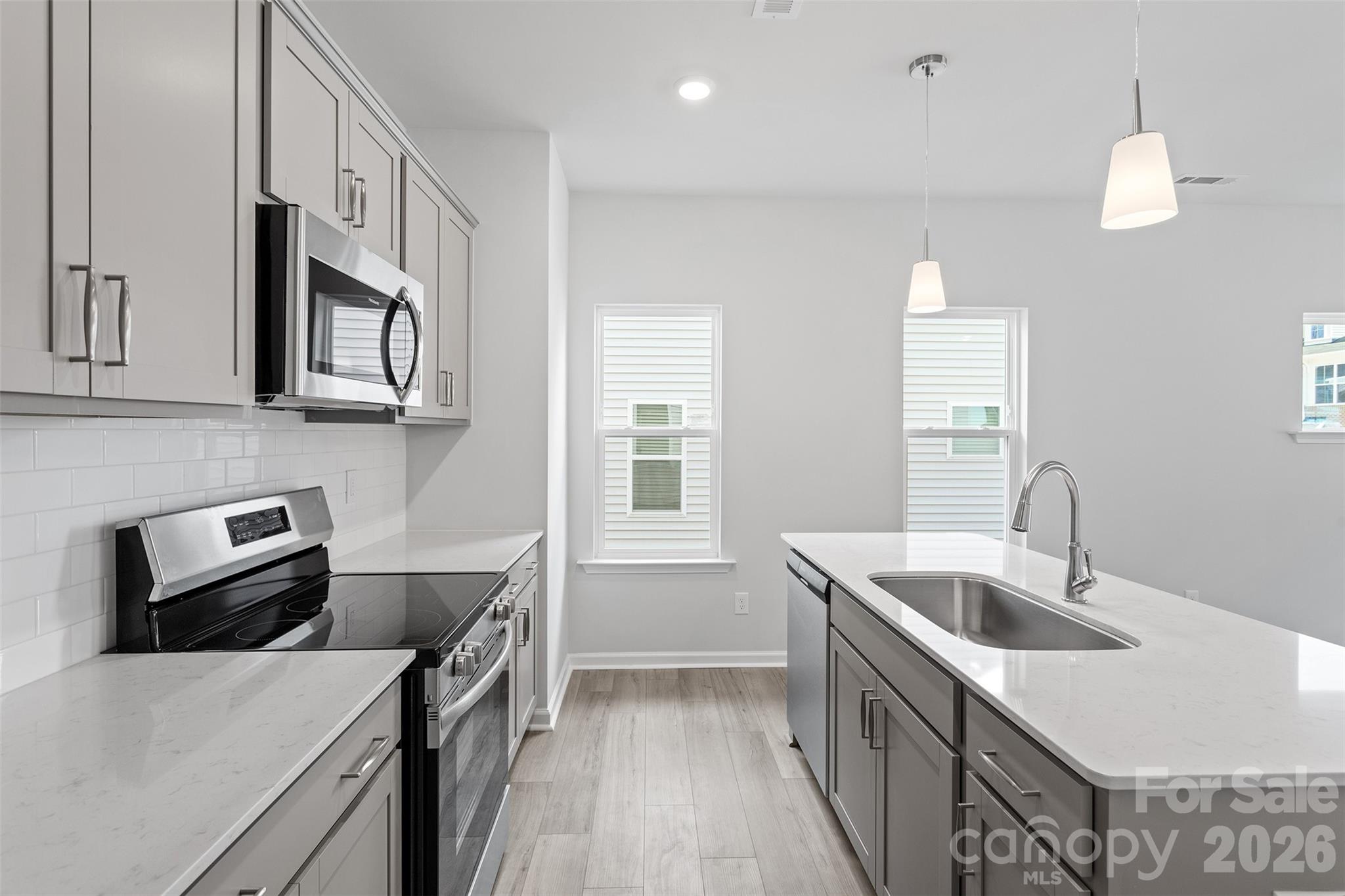 5869 Tuckaseegee Road, Unit 1 Charlotte, NC 28208 - Photo 9 of 30 a kitchen that has a sink and a stove