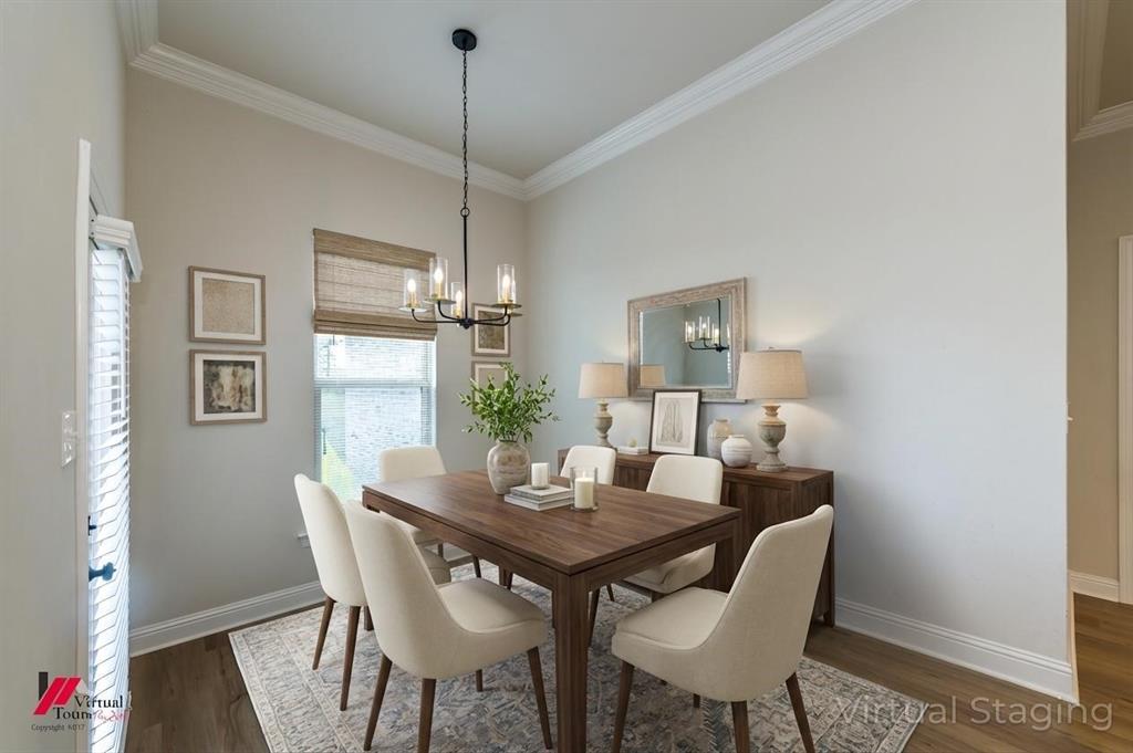 331 Hummingbird Lane Princeton, LA 71067 - Photo 10 of 34 AI Virtually added some staging. Dining area featuring crown molding, dark wood-type flooring, and suspended lighting
