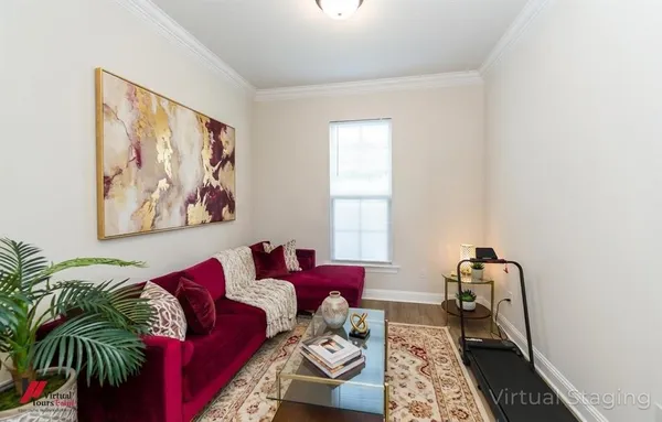 a living room with furniture and a wooden floor