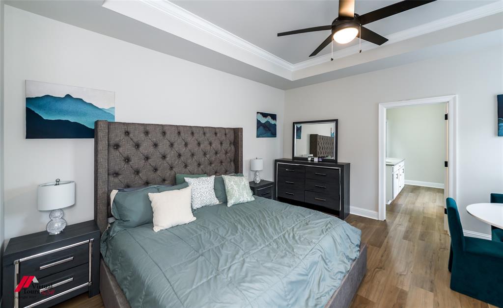 331 Hummingbird Lane Princeton, LA 71067 - Photo 15 of 34 Bedroom featuring dark wood-style floors, ornamental molding, a tray ceiling, and a ceiling fan
