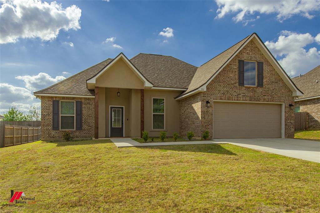 331 Hummingbird Lane Princeton, LA 71067 - Photo 2 of 34 View of front of home featuring concrete driveway, roof with shingles, brick siding, a porch, and stucco siding
