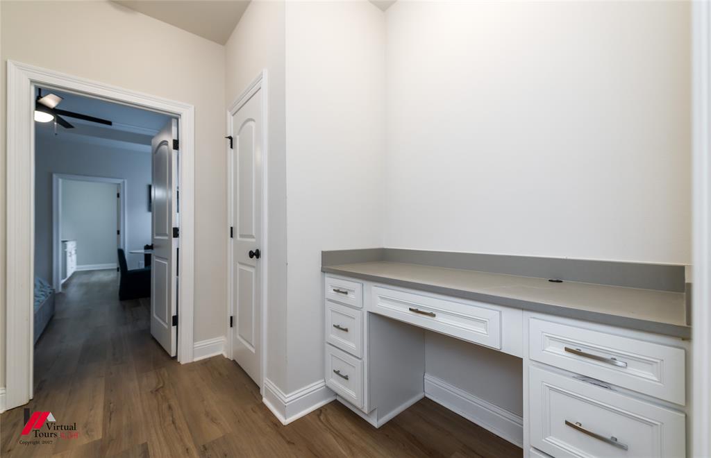 331 Hummingbird Lane Princeton, LA 71067 - Photo 23 of 34 Unfurnished office with built in desk, dark wood-style floors, and ceiling fan